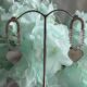 Silver toned heart dangle crystals studded earrings