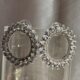 Circular crystal studded silver toned earrings