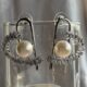 Silver toned crystals and pearl studded heart shape earrings