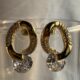 Gold toned crystals studded loop earring