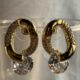 Gold toned crystals studded loop earring