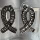 Silver toned ribbon-shaped earrings