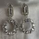 Sparkling circle silver toned stone studded drop earrings