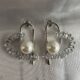 Silver toned crystals and pearl studded heart shape earrings