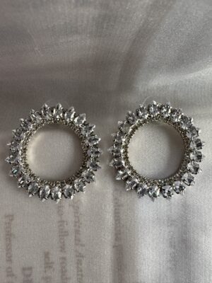 Circular crystal studded silver toned earrings
