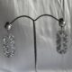 Dangling geometric crystal studded silver toned earrings