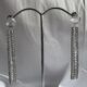 Stone studded glamorous long drop dazzling silver toned earrings
