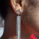 Stone studded glamorous long drop dazzling silver toned earrings