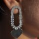 Silver toned heart dangle crystals studded earrings