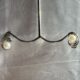 Silver-tone shimmering crystal studded curve with pearl beauty