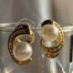 Gold-tone shimmering crystal studded curve with pearl beauty