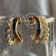 Gold-tone pearl hoops blend modern curves