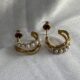 Gold-tone pearl hoops blend modern curves