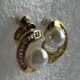 Gold-tone shimmering crystal studded curve with pearl beauty