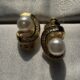 Gold-tone shimmering crystal studded curve with pearl beauty