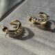 Gold-tone pearl hoops blend modern curves