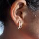 Gold-tone pearl hoops blend modern curves