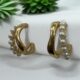 Gold-tone pearl hoops blend modern curves