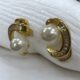 Gold-tone shimmering crystal studded curve with pearl beauty