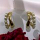 Gold-tone pearl hoops blend modern curves