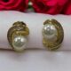 Gold-tone shimmering crystal studded curve with pearl beauty